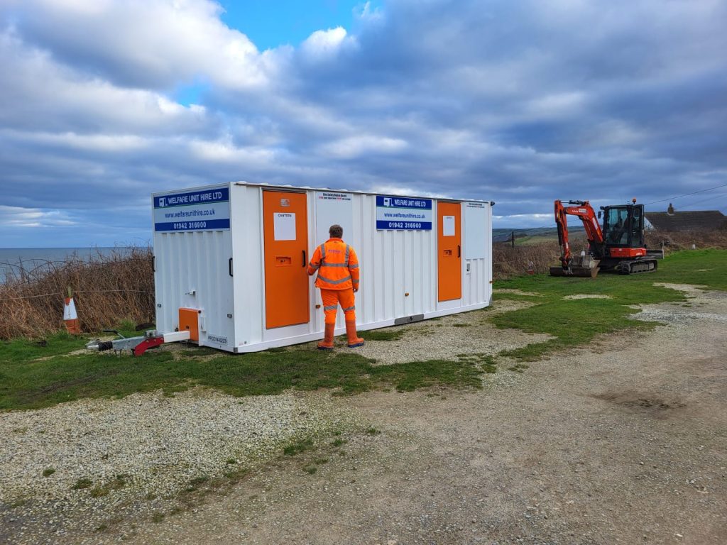 Civil engineering welfare unit on a groundworks site with the crew in hi-vis